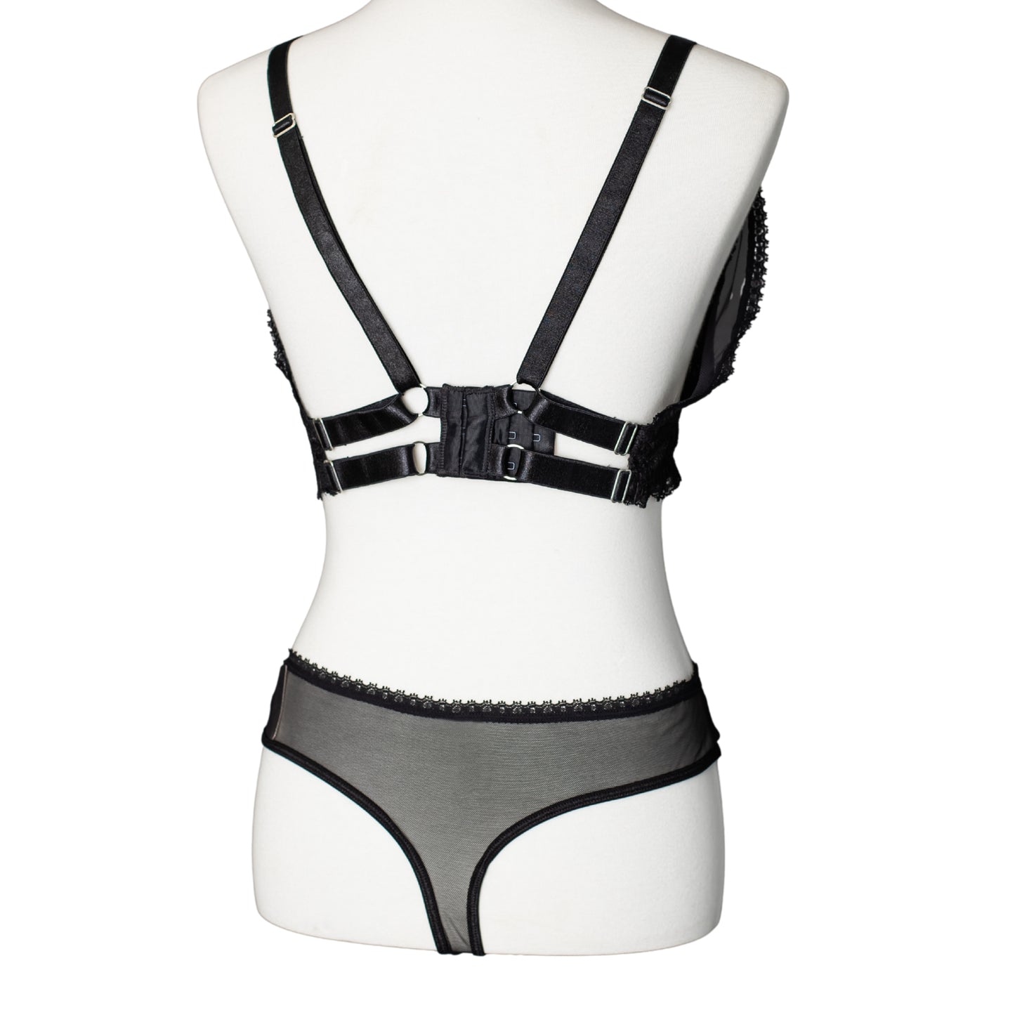 Back view of black lace and mesh bra and thong