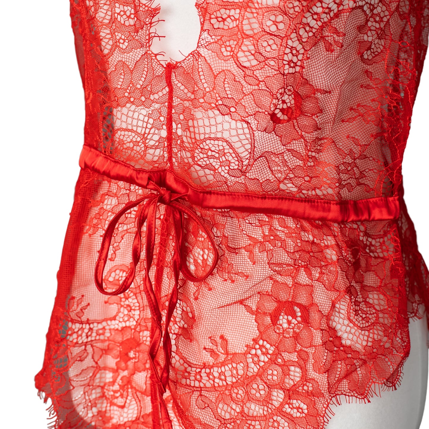 Detail photo of ribbon on the waist of a red lace teddy
