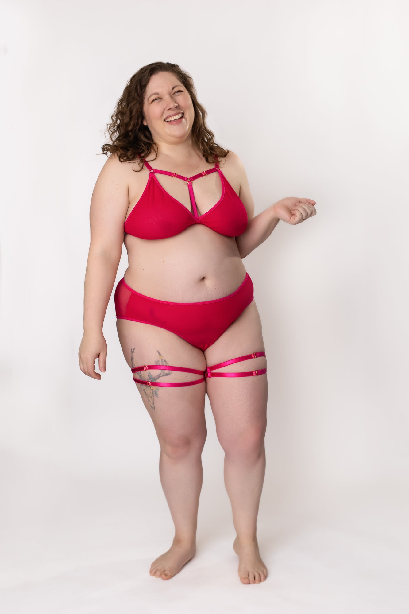 Plus-size woman standing in a hot pink lingerie set