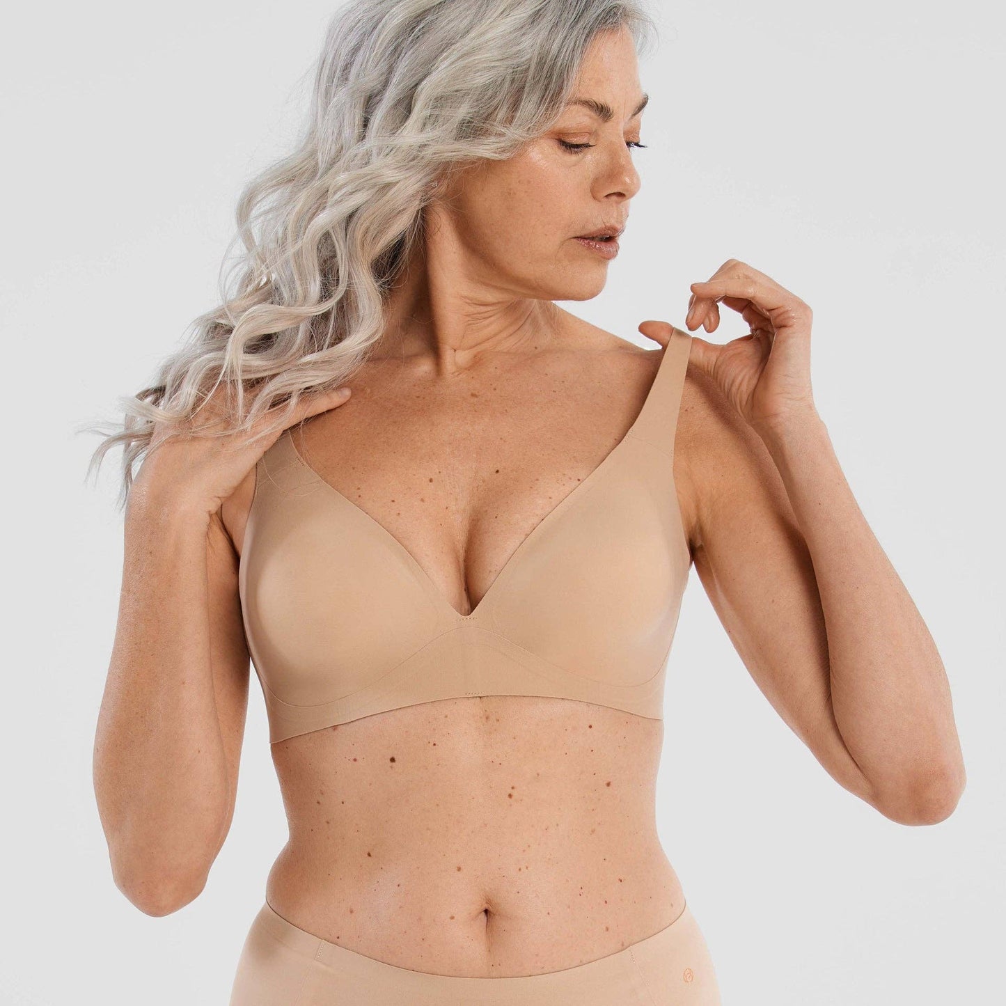 Starlette Plunge Bra in Sand color, showing deep plunge neckline and seamless construction
