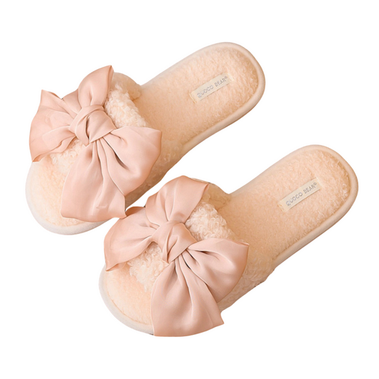Blush pink fuzzy open-toed slippers with a satin bow on the top