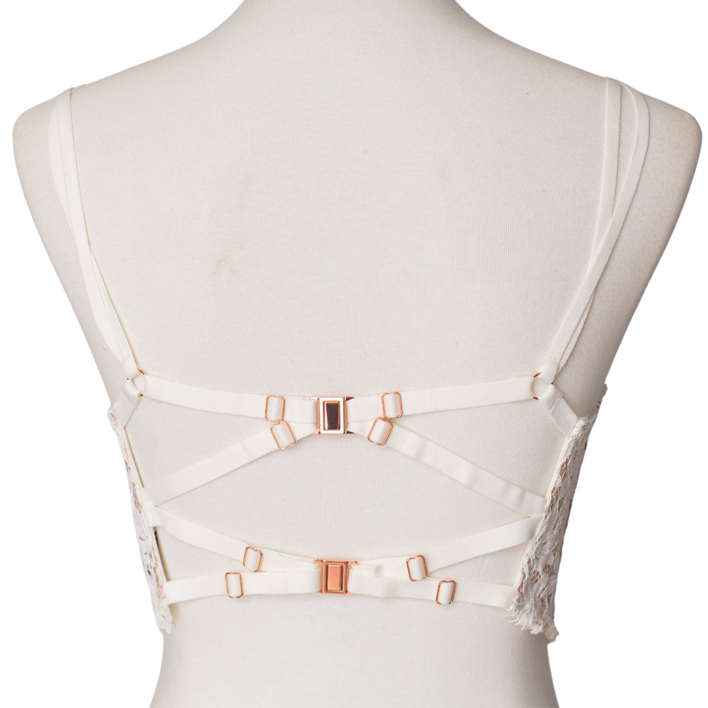 Back view of straps and rose gold clasps on a white bustier