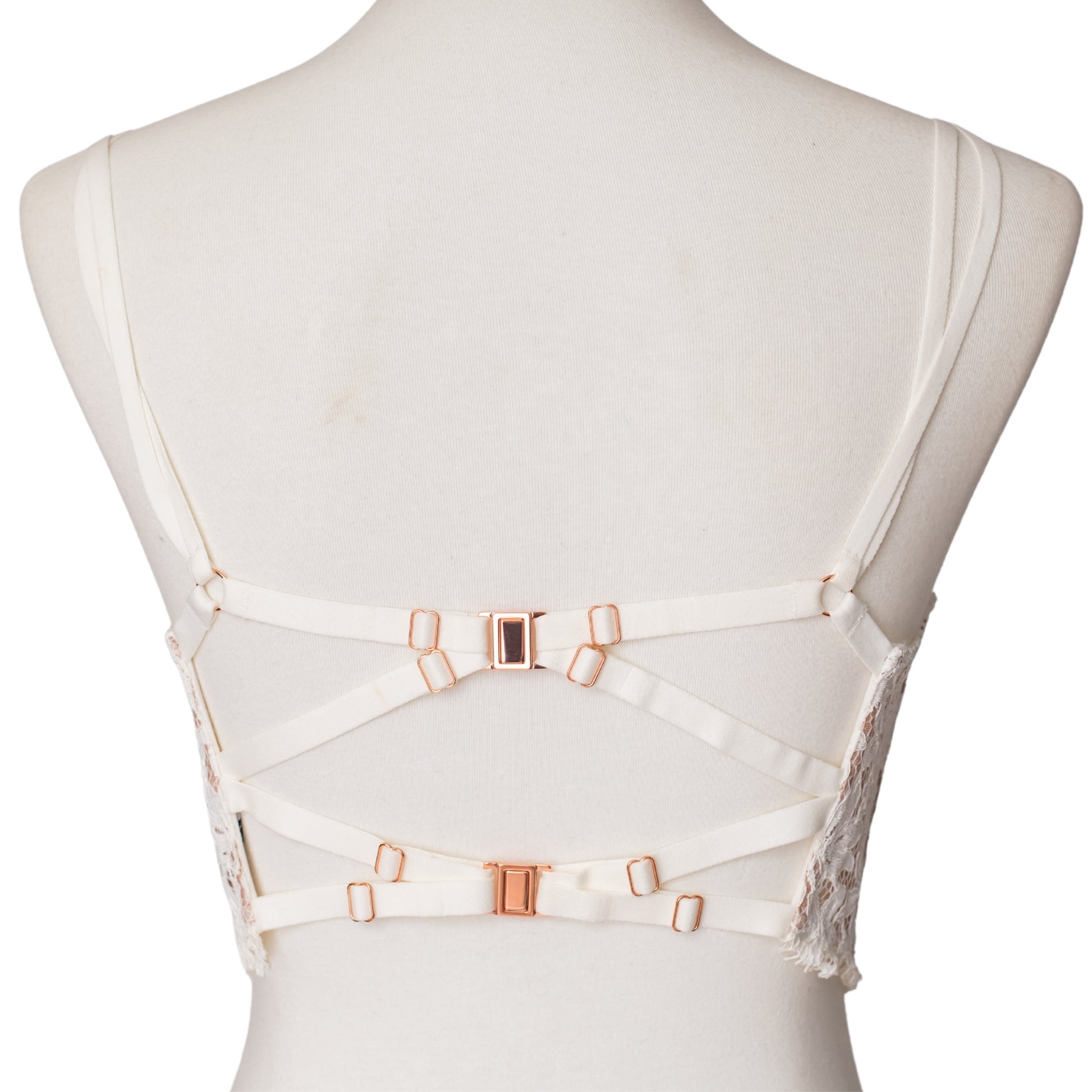 Back view of straps and rose gold clasps on a white bustier