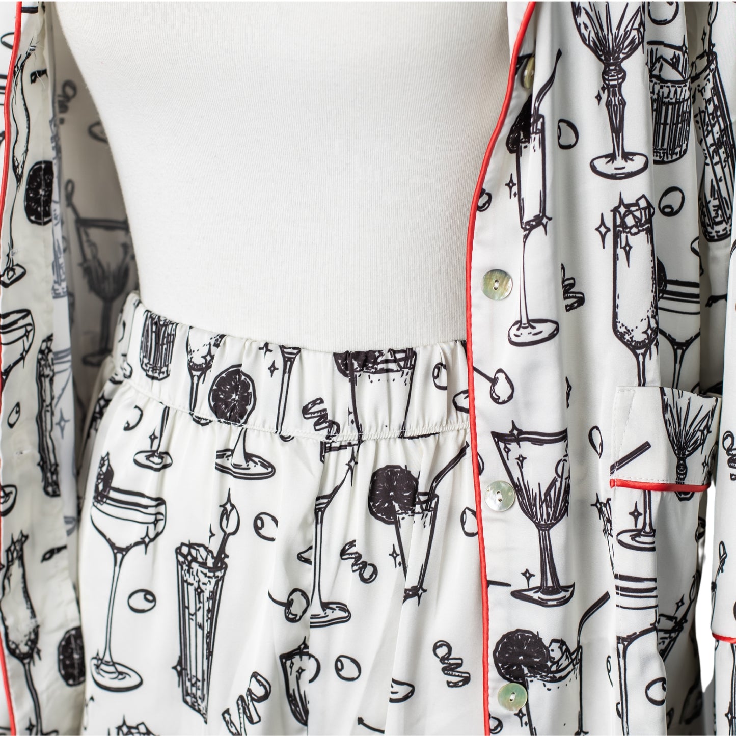 Close-up of cocktail-printed satin pajama pants and shirt