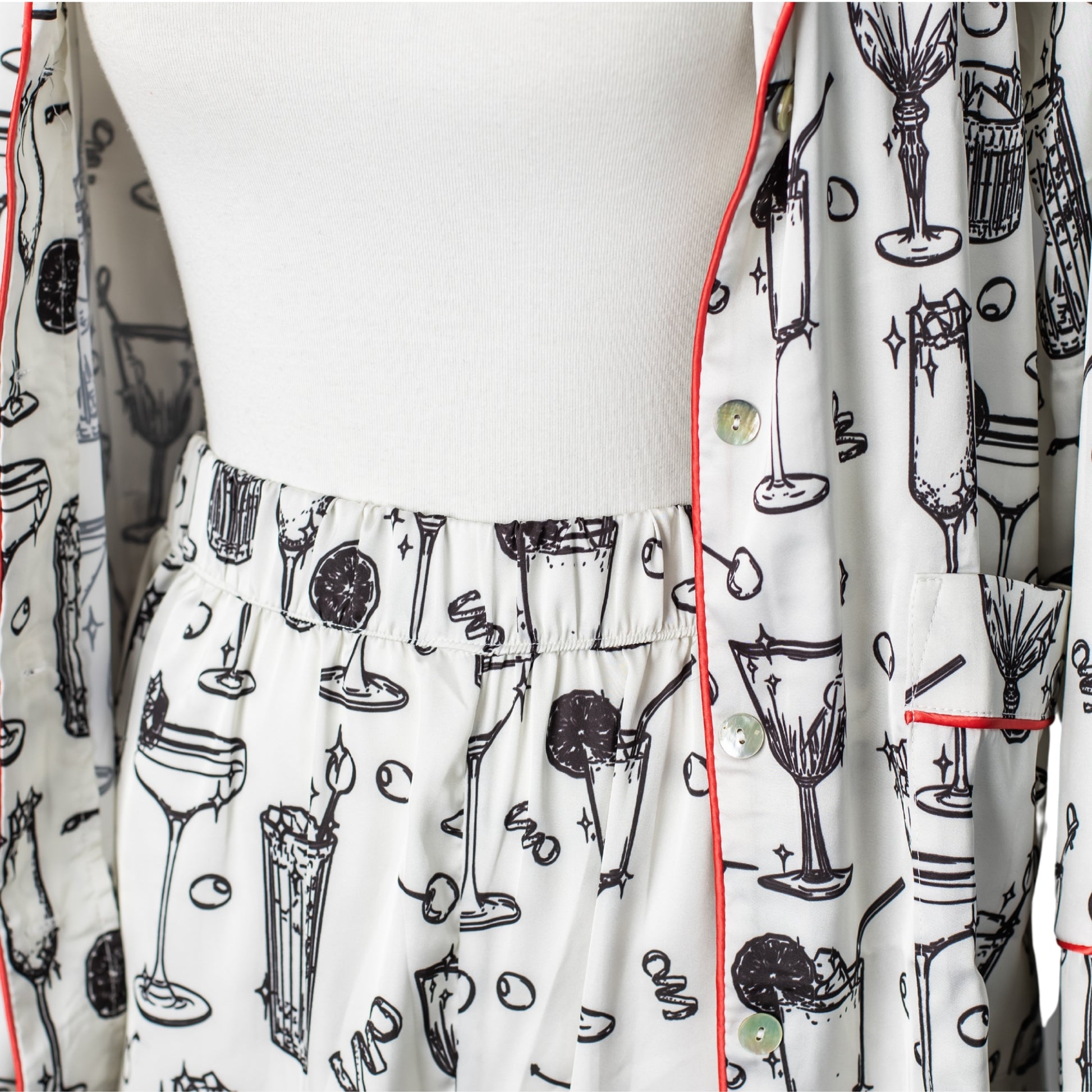 Close-up of cocktail-printed satin pajama pants and shirt
