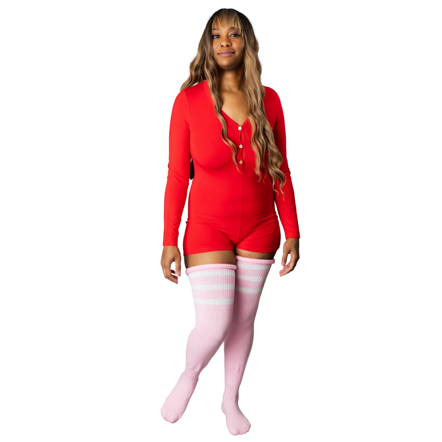 Woman wearing red onesie pajamas with thigh-high pink socks