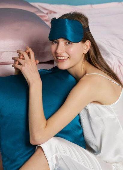 Woman wearing a teal silk eye mask