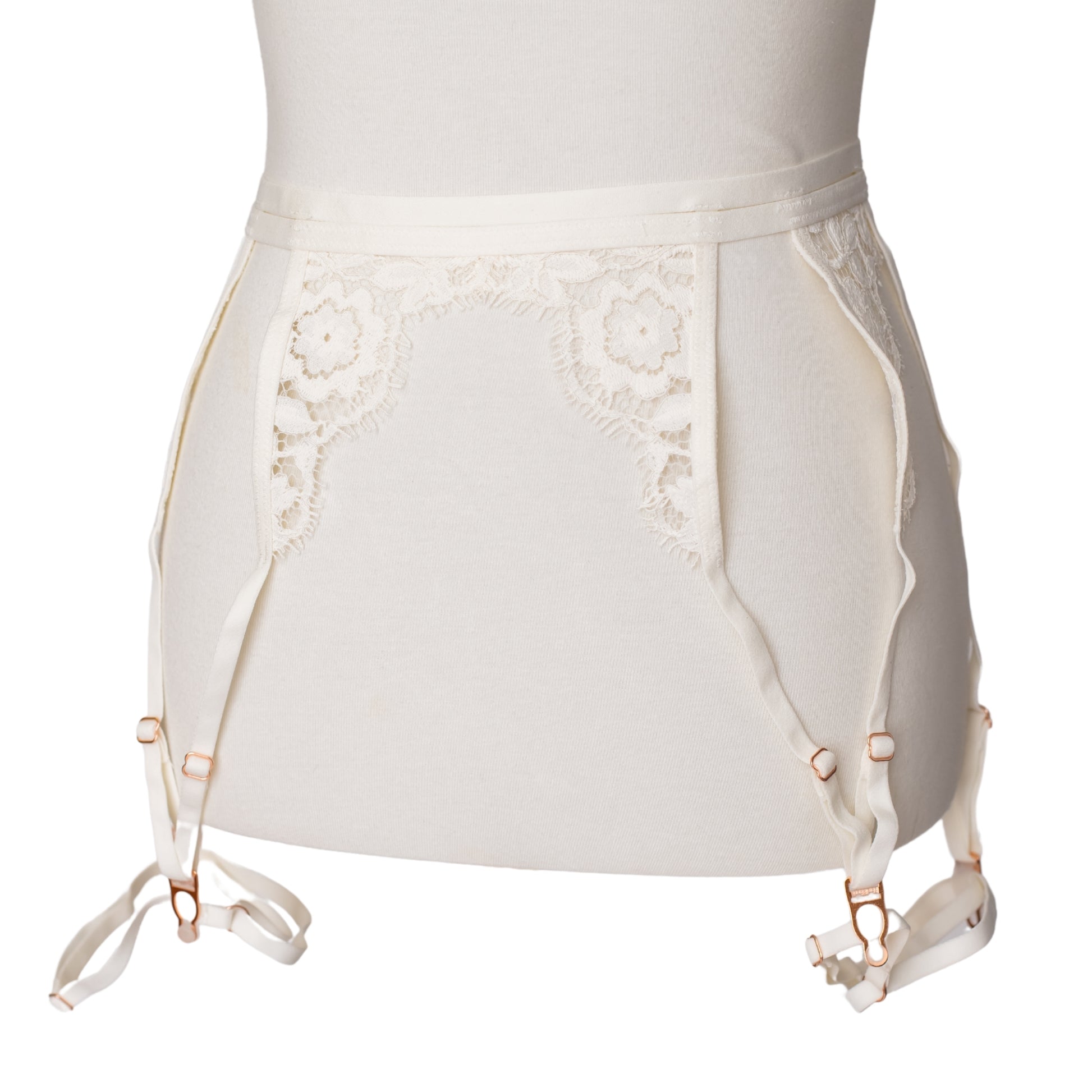 Front view of a white lace garter belt and leg garters with rose gold hardware