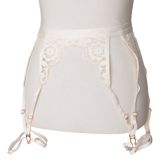 Front view of a white lace garter belt and leg garters with rose gold hardware