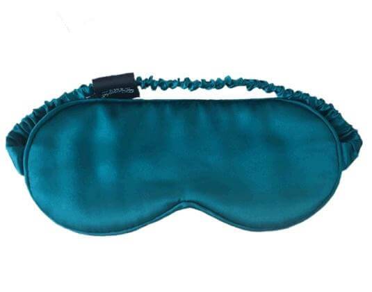A rich, teal sleep mask made of 100% silk